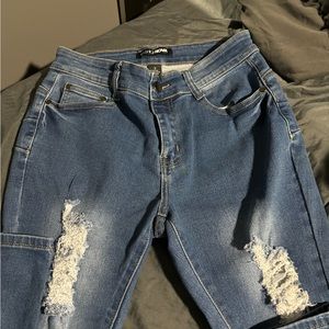 blue washed mid waist distressed skinny jeans